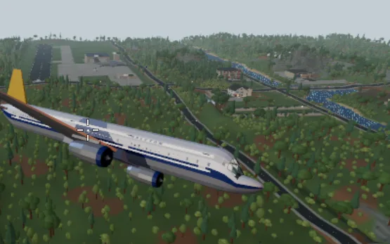 A white airliner with a yellow tail banks over forested hills and a winding road, an airfield in the distance.